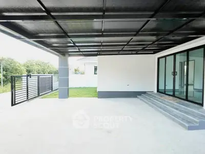 Modern covered patio with sliding glass doors and garden view