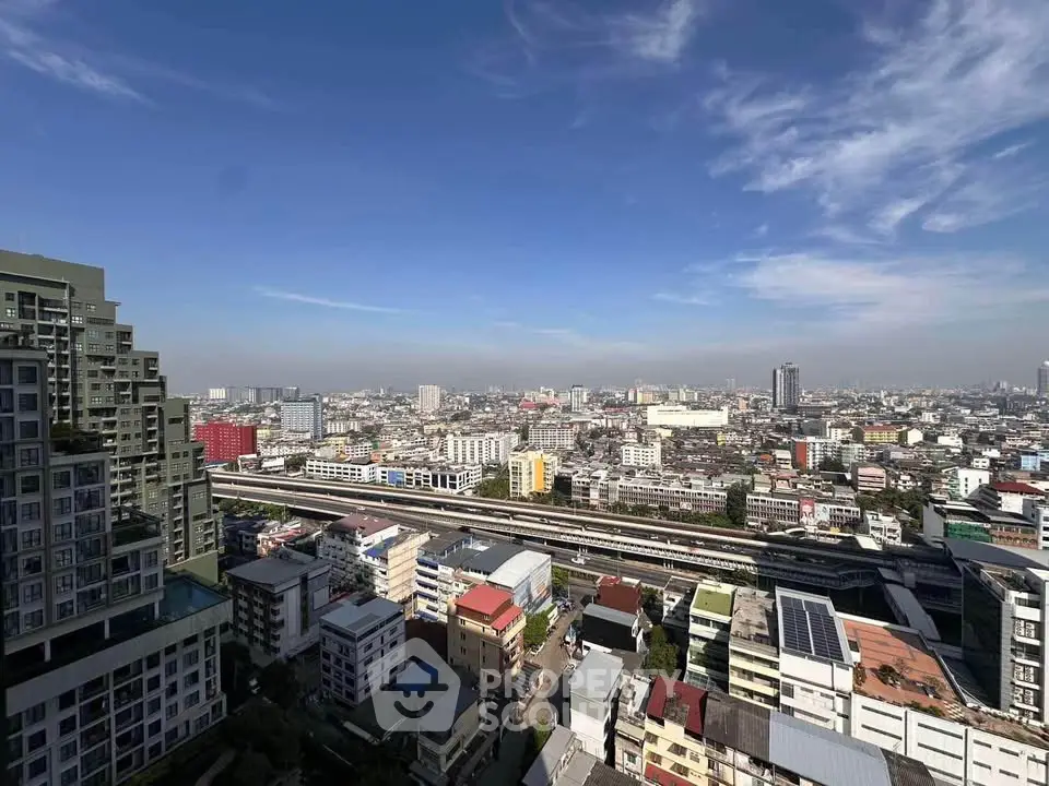 Stunning cityscape view from high-rise building showcasing urban skyline and clear blue sky.