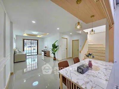 Modern open-plan living and dining area with stylish decor and natural light.