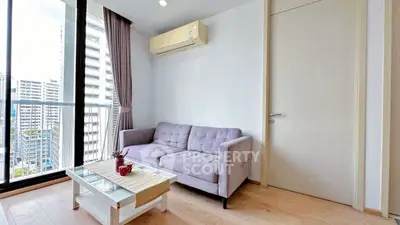 Modern living room with city view, featuring a cozy sofa and stylish coffee table.