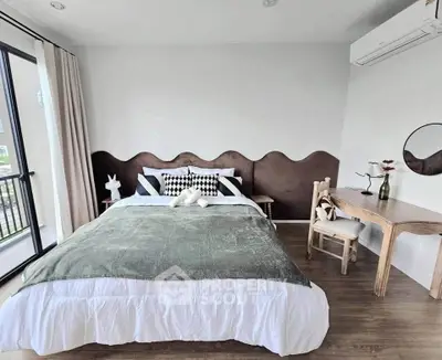 Stylish bedroom with modern decor and natural light, featuring a cozy bed and elegant furnishings.