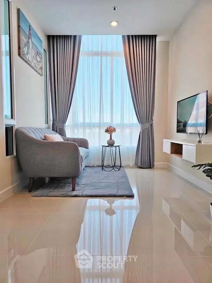 Modern living room with elegant decor, large window, and cozy seating area in a stylish apartment.