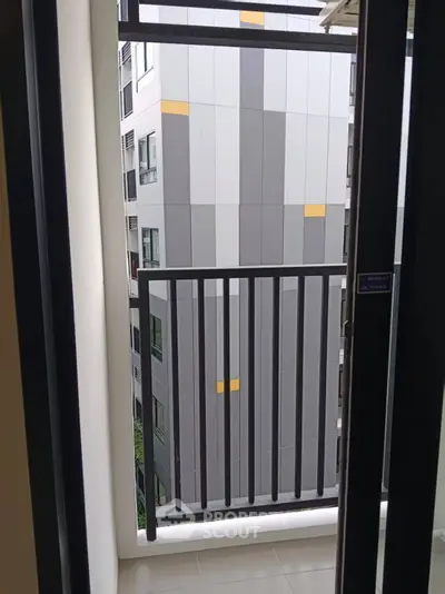 Modern apartment balcony with sleek railing and urban view