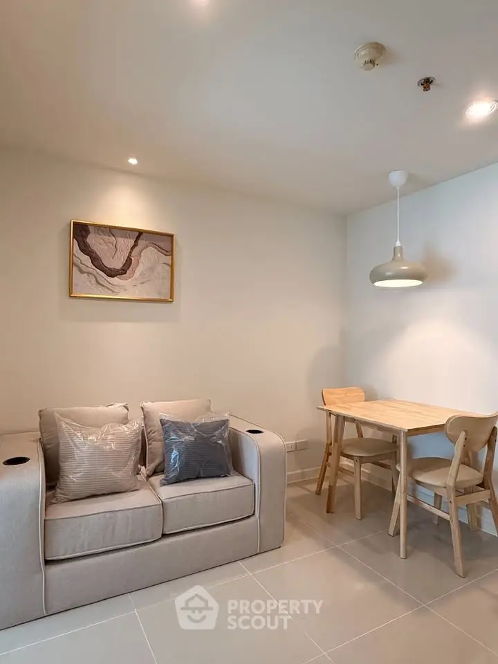 Cozy living room with modern decor and dining area in a stylish apartment.