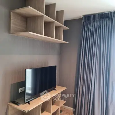 Modern living room with sleek TV setup and stylish shelving