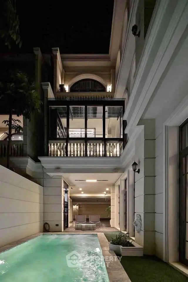 Luxurious modern villa with private pool and elegant balcony at night