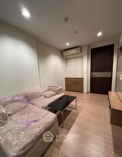 Modern living room with sleek furniture and wooden flooring, ideal for cozy gatherings.