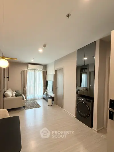 Modern living room with sleek design and in-unit washer