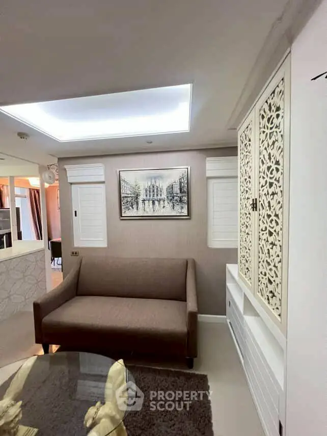 Stylish living room with elegant sofa and decorative wall art in modern apartment.