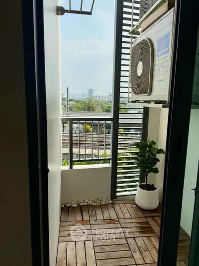 Charming balcony with wooden flooring and city view, perfect for relaxation.