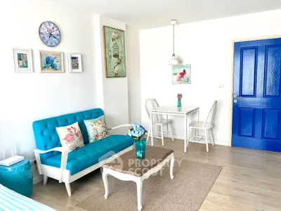 Charming living room with vibrant blue accents and cozy seating area