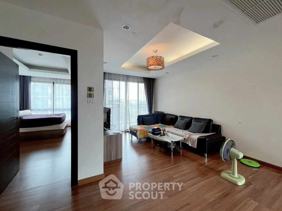 Spacious living room with modern decor and natural light in a stylish apartment