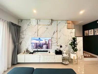 Modern living room with marble accent wall and sleek entertainment center