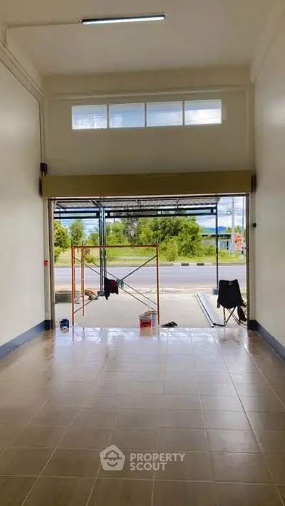 Spacious commercial unit with large open entrance and tiled flooring, ideal for business setup.
