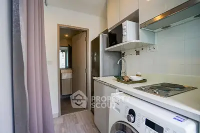 Compact modern kitchen with washing machine and sleek appliances