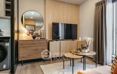 Modern living room with stylish decor, TV, and washing machine in a cozy apartment setting.