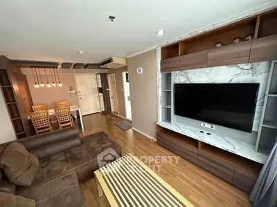 Spacious living room with modern decor and large TV unit