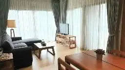 Spacious living room with large windows and modern furnishings