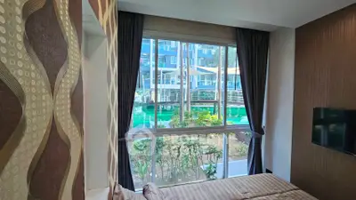 Luxurious bedroom with pool view in modern apartment complex
