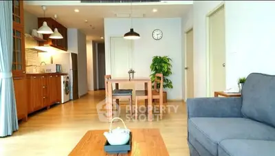 Spacious living room with modern decor and open kitchen layout