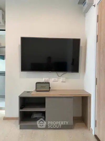 Modern living room with wall-mounted TV and stylish cabinet