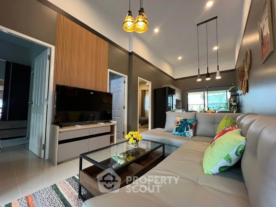 Modern living room with stylish decor, large sectional sofa, and elegant lighting in a contemporary home.