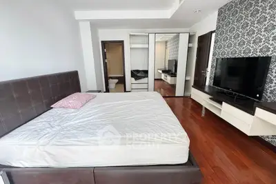 Spacious bedroom with modern decor and large bed in a stylish apartment.