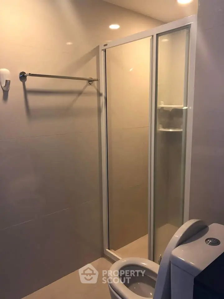 Modern bathroom with glass shower enclosure and sleek fixtures
