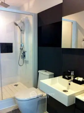 Modern bathroom with sleek fixtures and glass shower enclosure