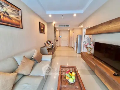 Modern living room with elegant decor and open layout, featuring a cozy sofa and sleek TV unit.