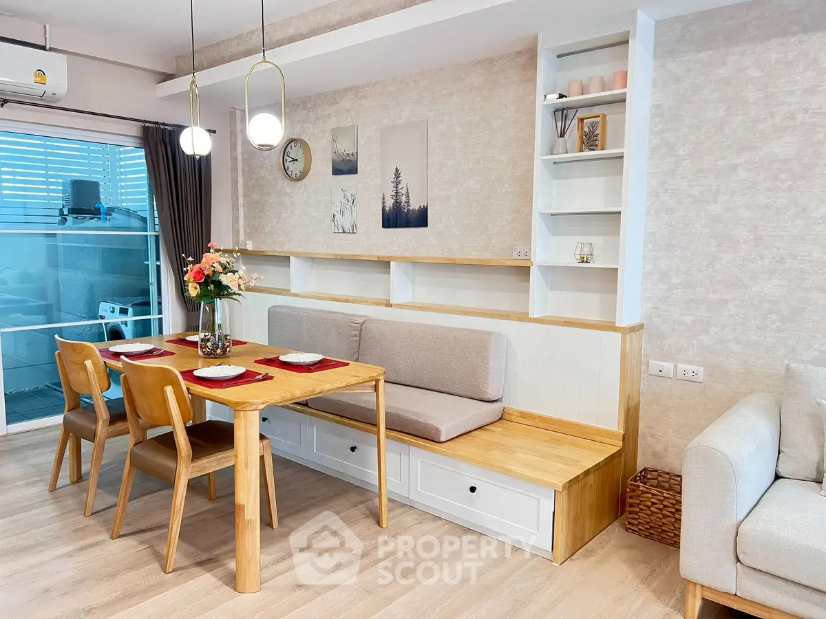 Stylish dining area with wooden table and cozy seating in modern apartment.