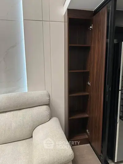 Modern living room with sleek built-in wooden storage cabinet and plush sofa