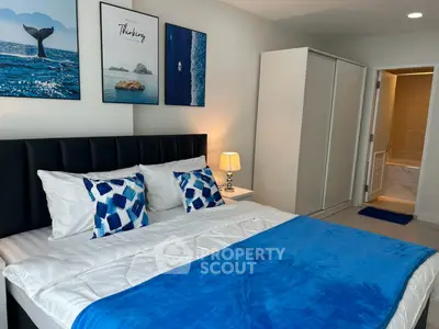 Modern bedroom with stylish decor and ensuite bathroom in a contemporary apartment.