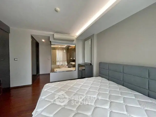 Modern bedroom with ensuite bathroom and sleek design in a stylish apartment.