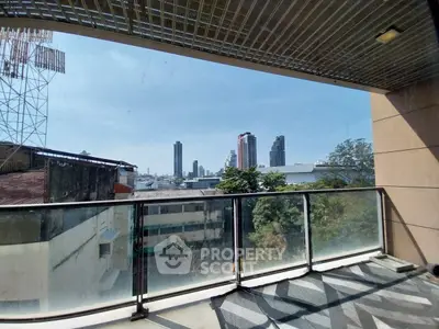 Spacious balcony with city skyline view, perfect for urban living enthusiasts.