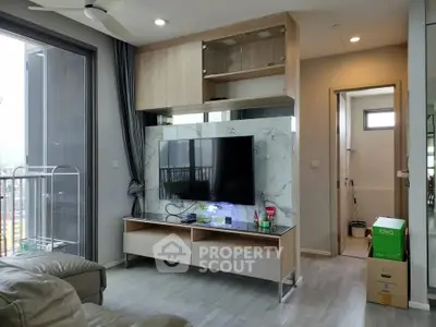 Modern living room with TV, marble accent wall, and balcony view in stylish apartment.