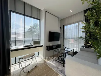 Modern living room with large windows, stylish decor, and natural light