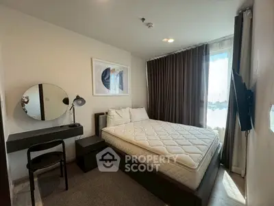 Modern bedroom with stylish decor and natural light, featuring a comfortable bed and sleek furniture.