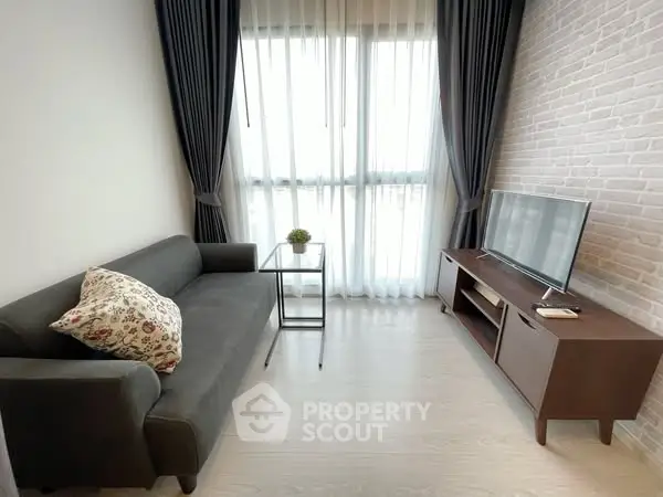 Modern living room with sleek sofa, TV, and large window with curtains.