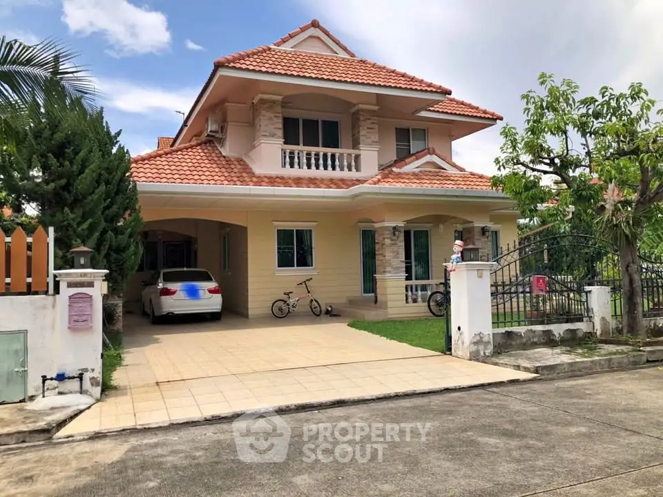 Charming two-story house with red-tiled roof and spacious driveway in serene neighborhood.