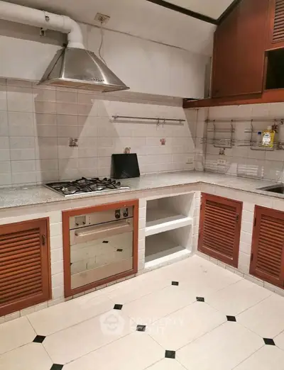Charming kitchen with gas stove and ample storage, perfect for culinary enthusiasts.