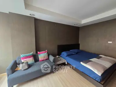 Modern bedroom with stylish decor and cozy seating area