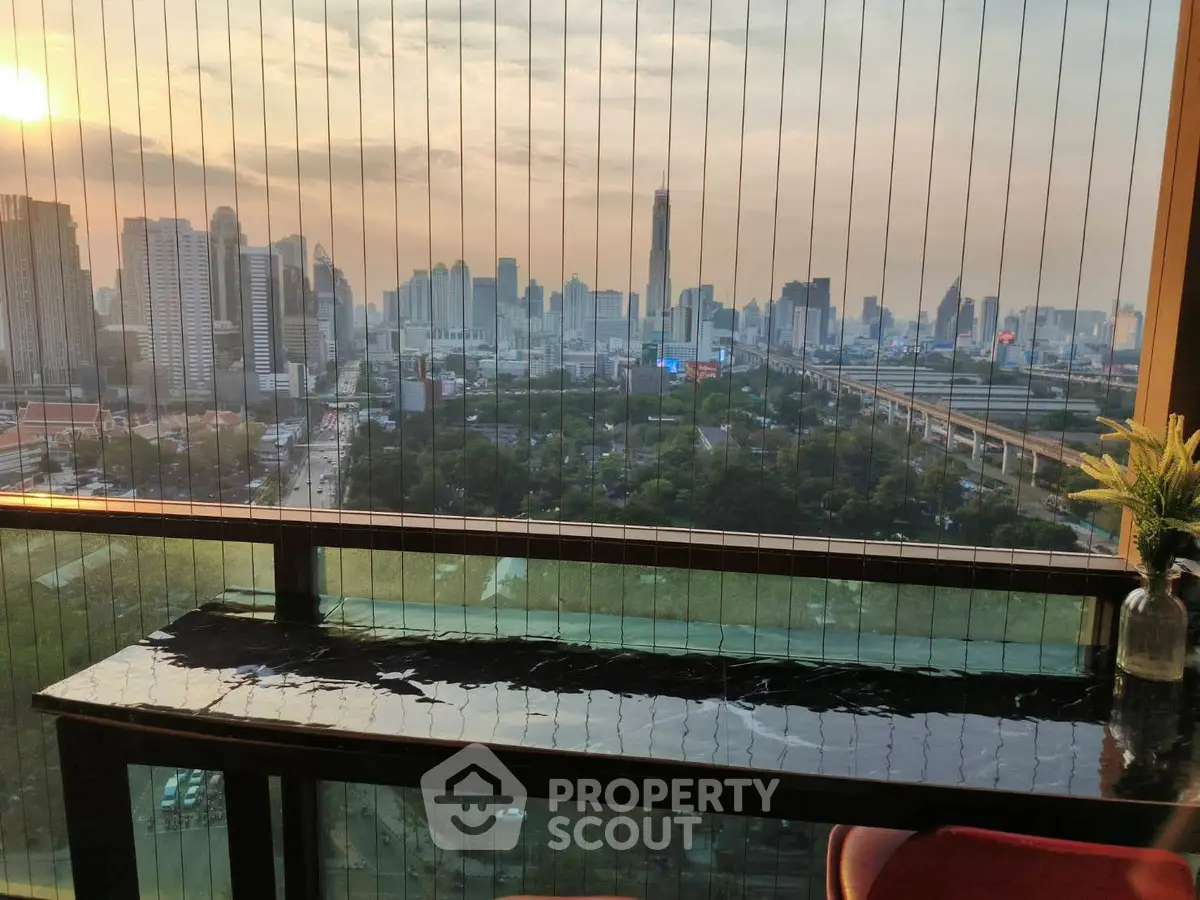 Stunning city skyline view from a high-rise balcony at sunset, perfect for urban living.