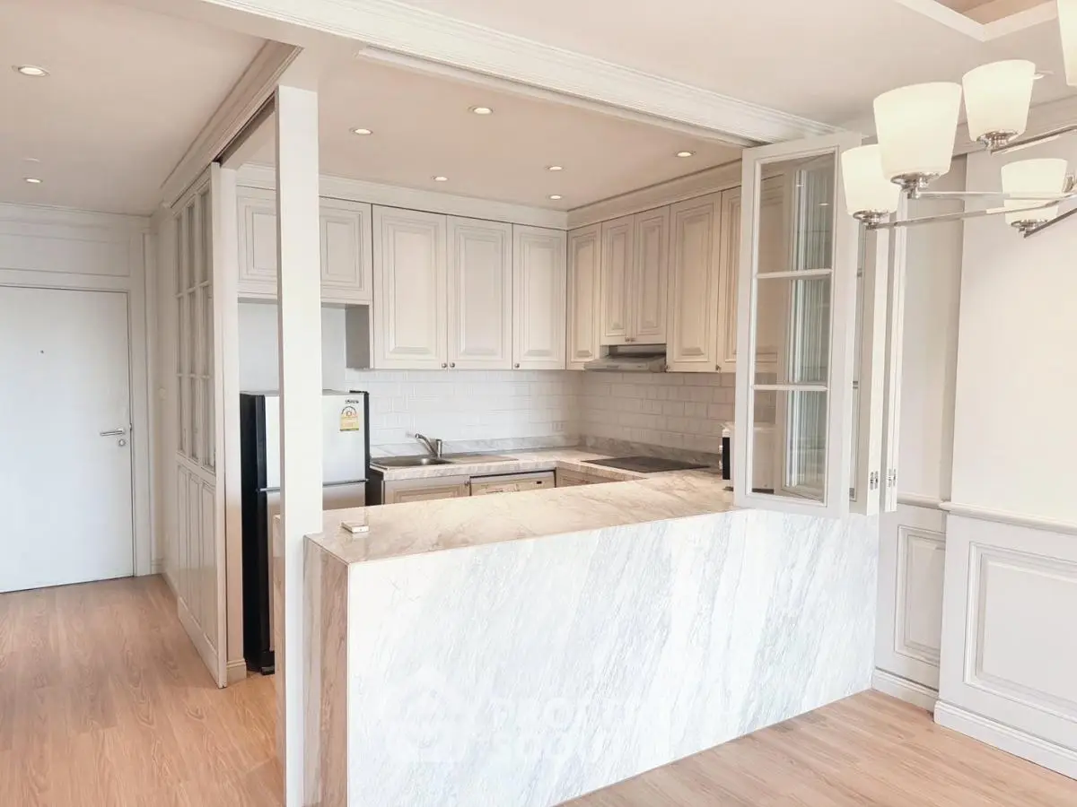 Elegant kitchen with marble countertop and open layout in modern apartment