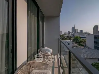 Modern balcony with city view and stylish seating in urban apartment