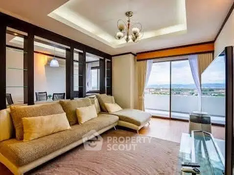 Spacious living room with modern decor and large balcony offering stunning views.