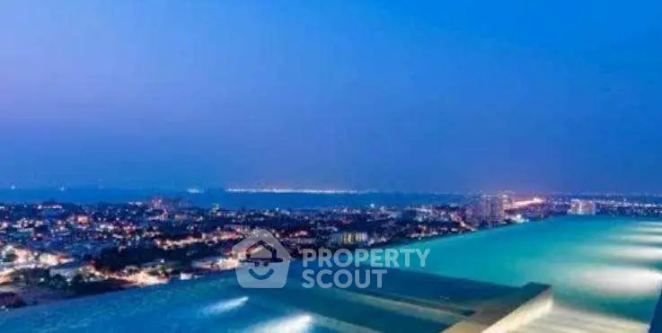 Stunning rooftop infinity pool with breathtaking city and ocean views at dusk.