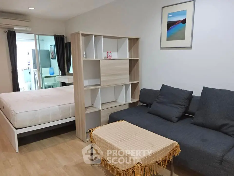 Modern studio apartment with cozy living area and stylish partition