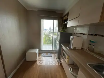 Cozy kitchen with modern appliances and city view from balcony