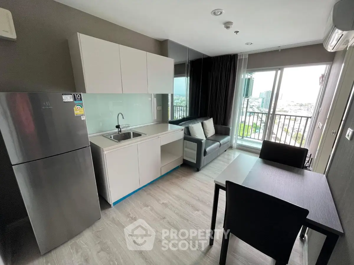 Modern apartment living room with balcony view, sleek kitchen, and stylish furnishings.